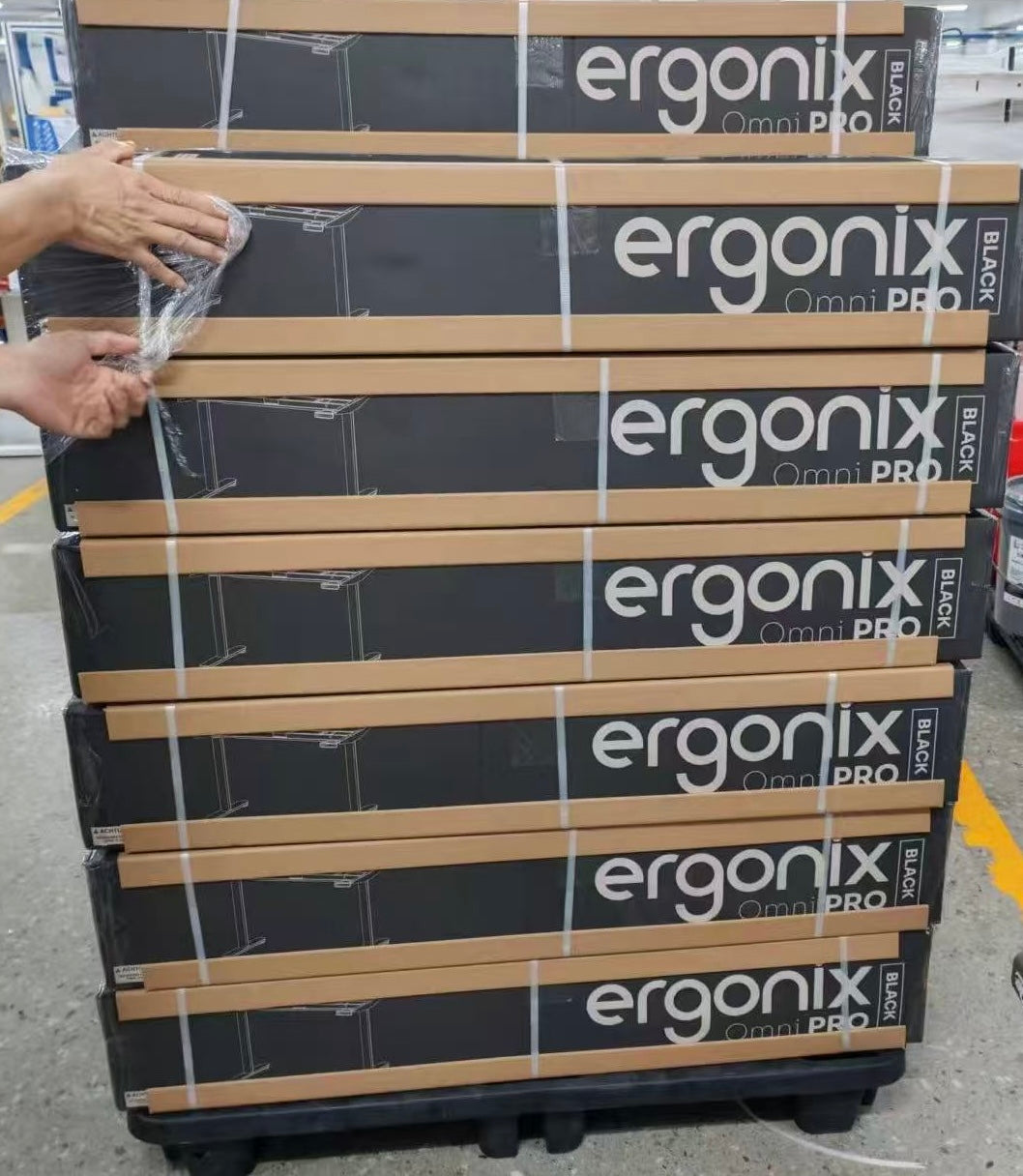 Packed Ergonix OmniPRO desks stacked on a pallet
